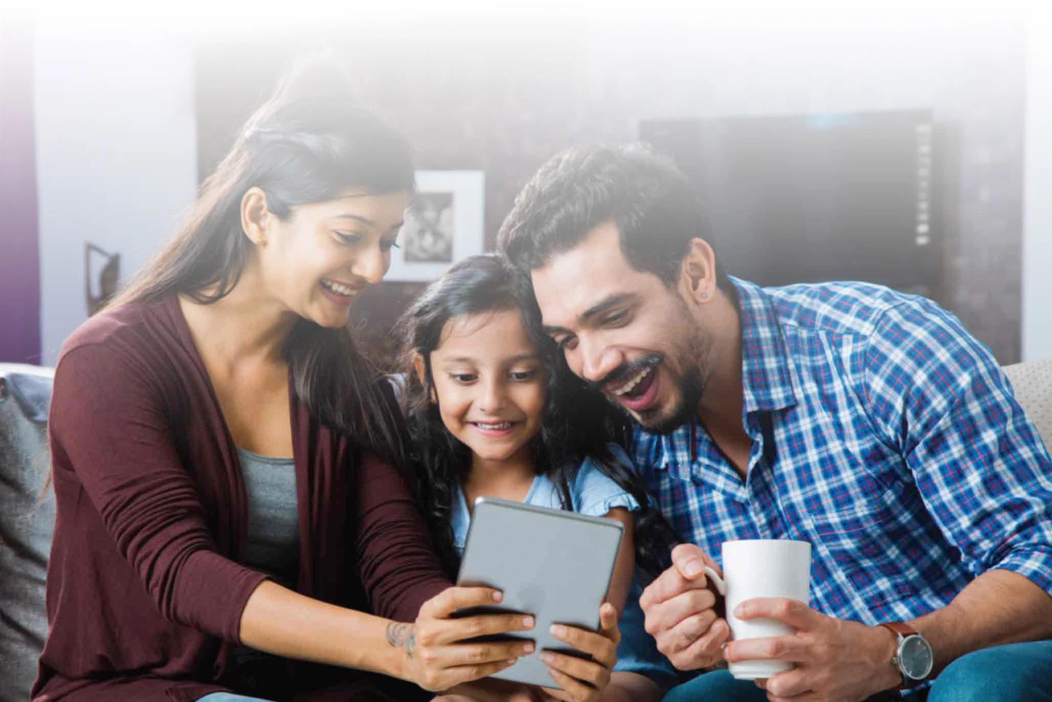 An Indian family reviewing financial plans together on a tablet at home